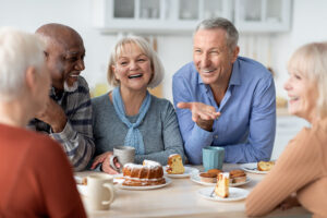 Multiracial group of happy senior people sitting around the table